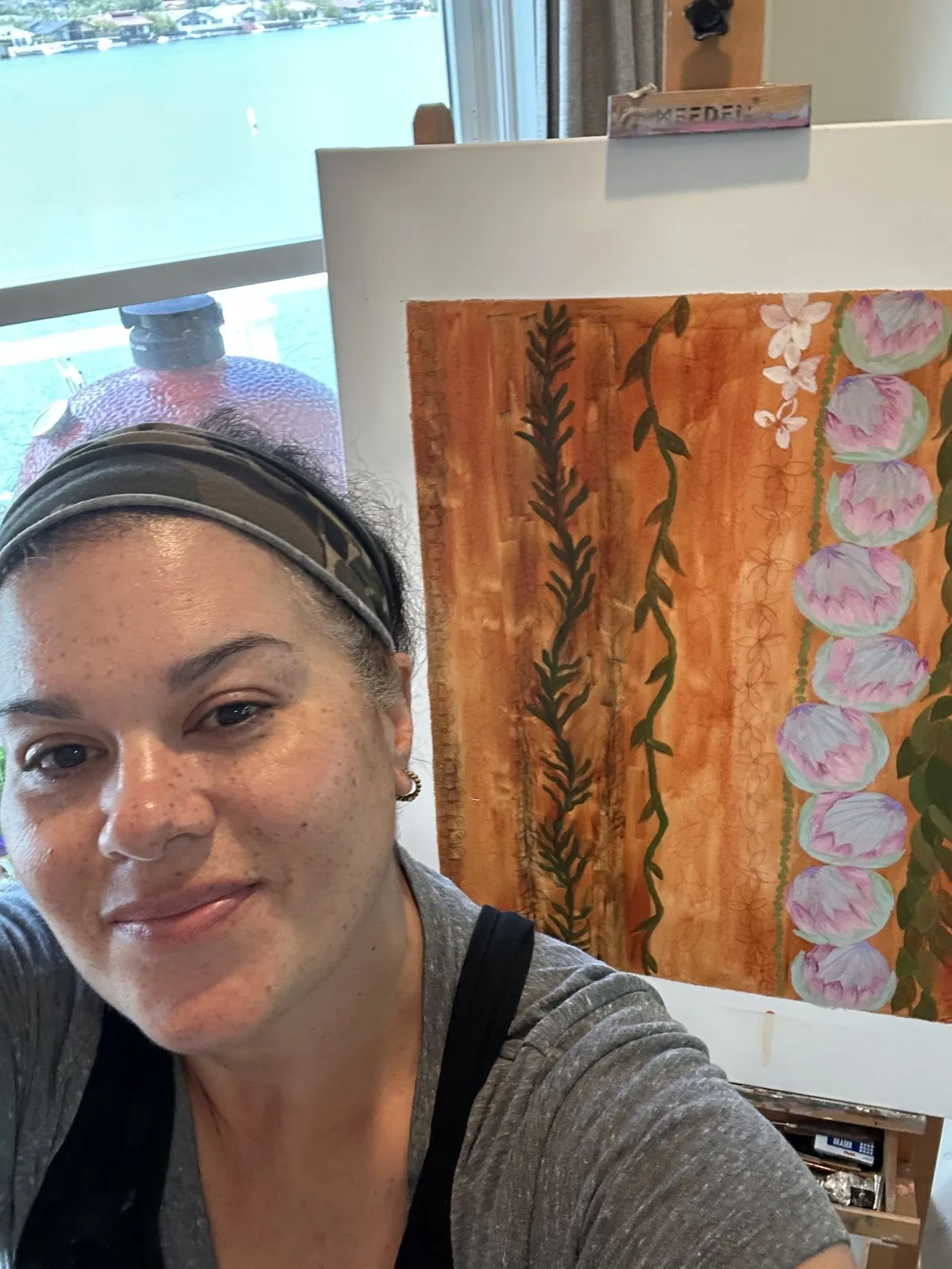 MJ Costello painting in her Hawaii Kai studio overlooking the water.